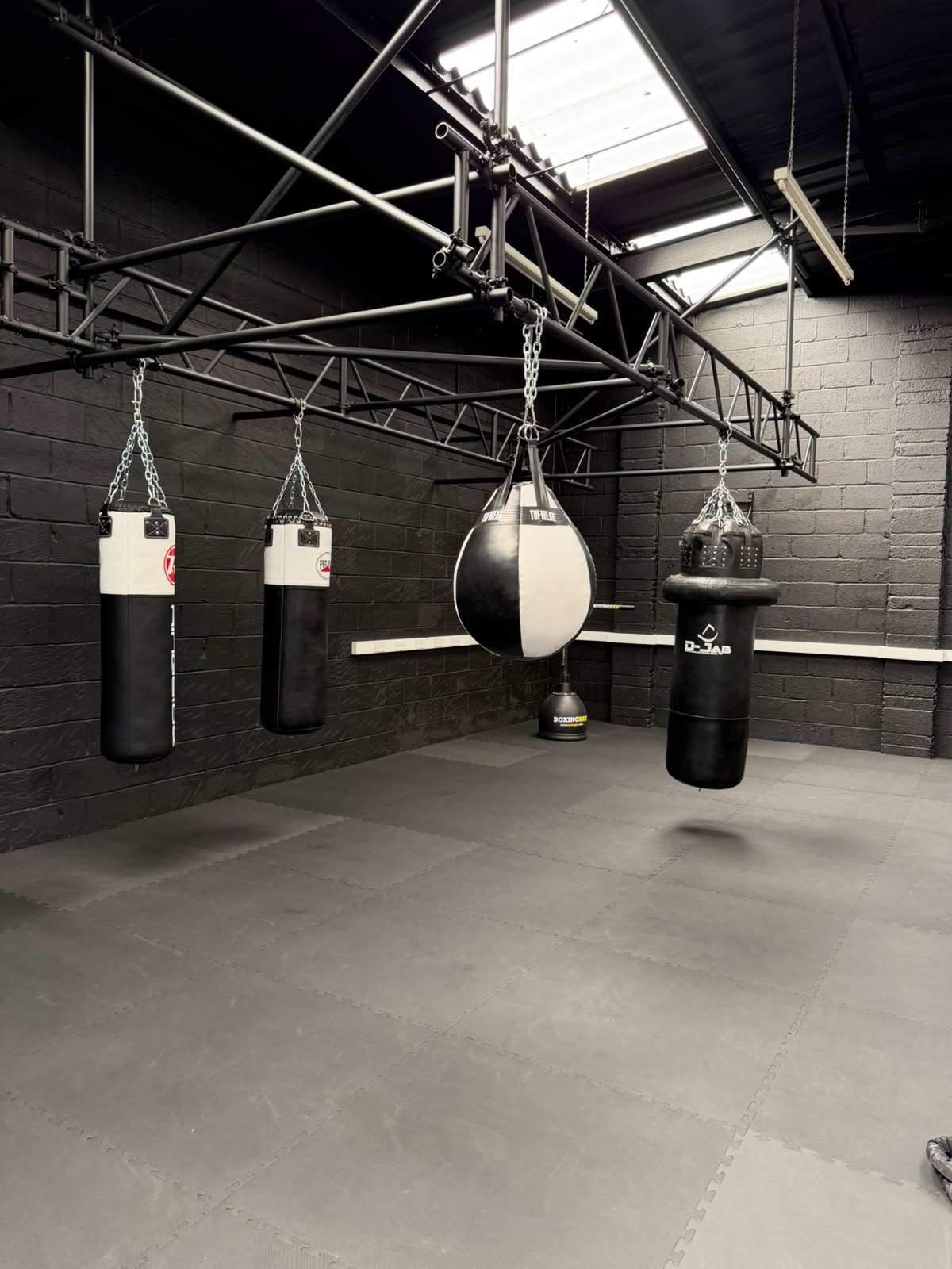 Heavy bags and training space inside the Ringside Learning boxing gym